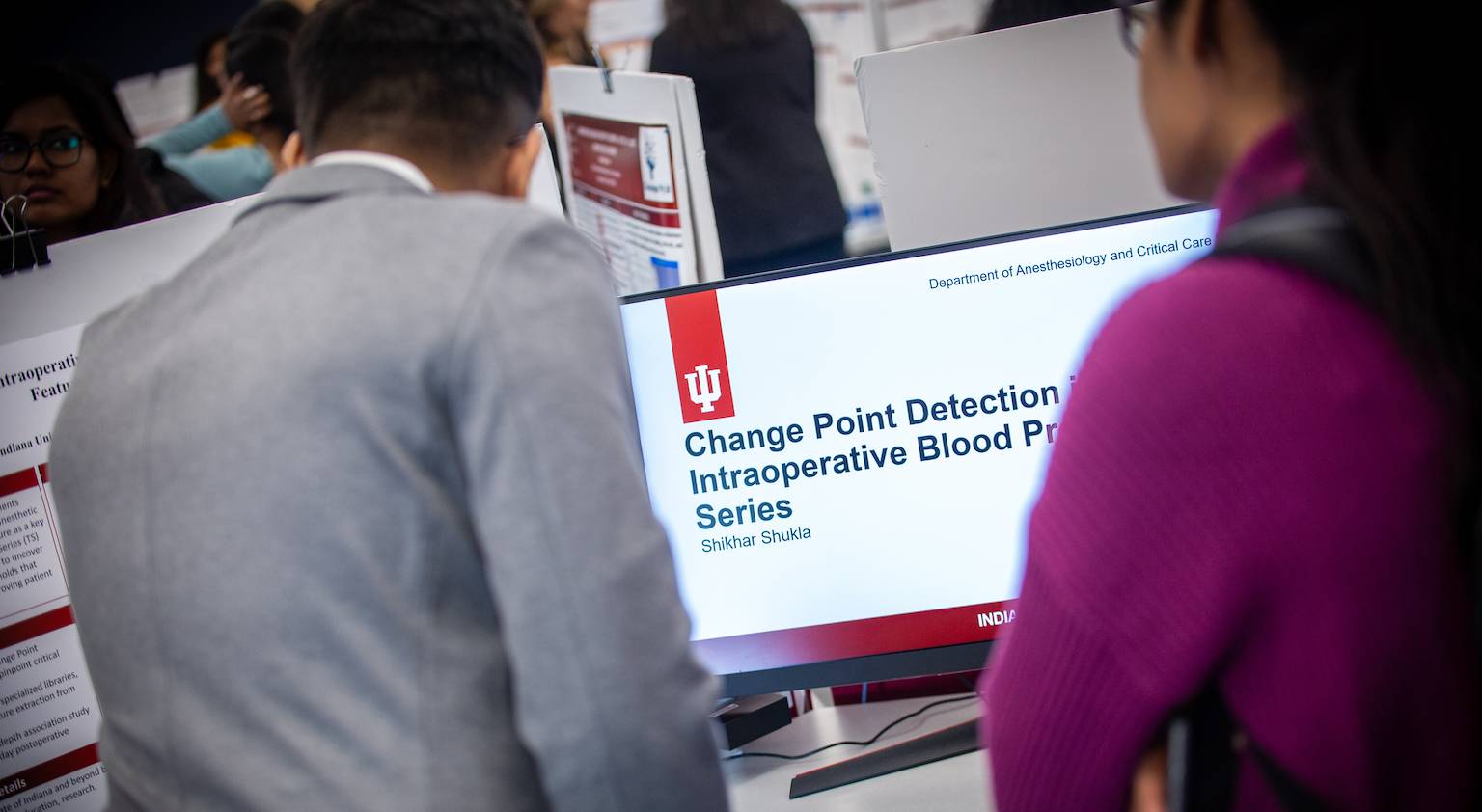 Image of attendees watching a health informatics graduate student slide presentation for their anesthesiology showcase project