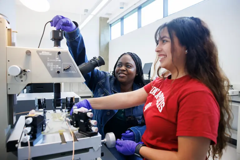 Students using a biomedical device in the INDI lab